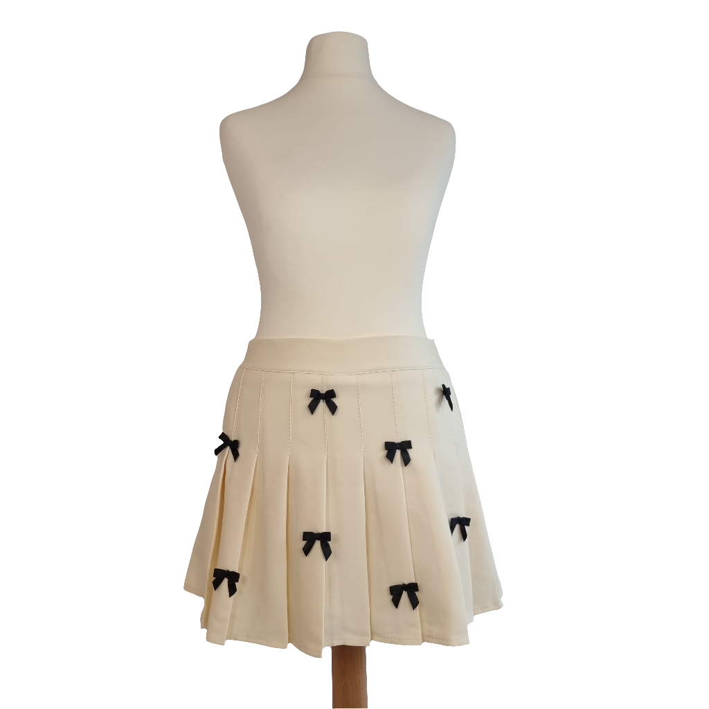 Cream Pleated Mini Skirt with Black Bow Accents