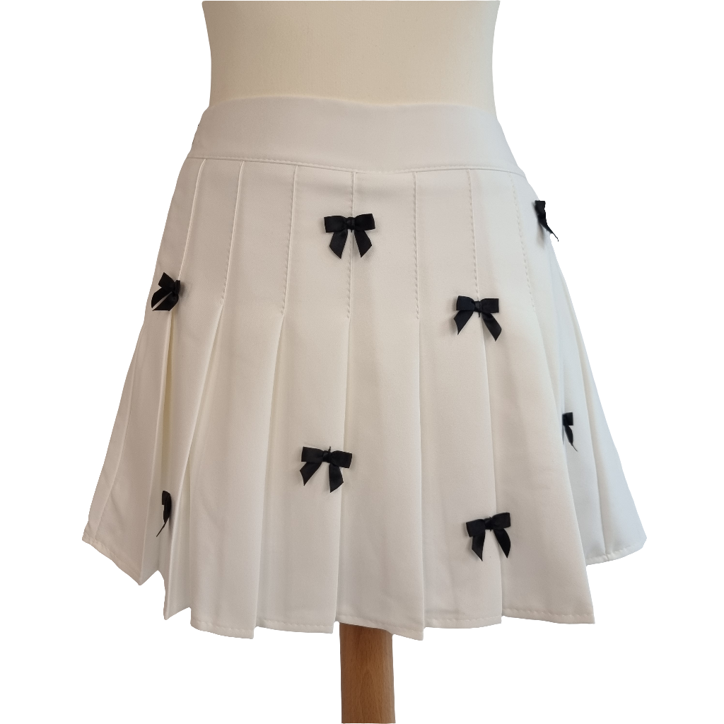 White Pleated Mini Skirt with Black Bow Embellishments