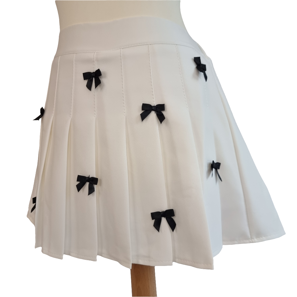 White Pleated Mini Skirt with Black Bow Embellishments