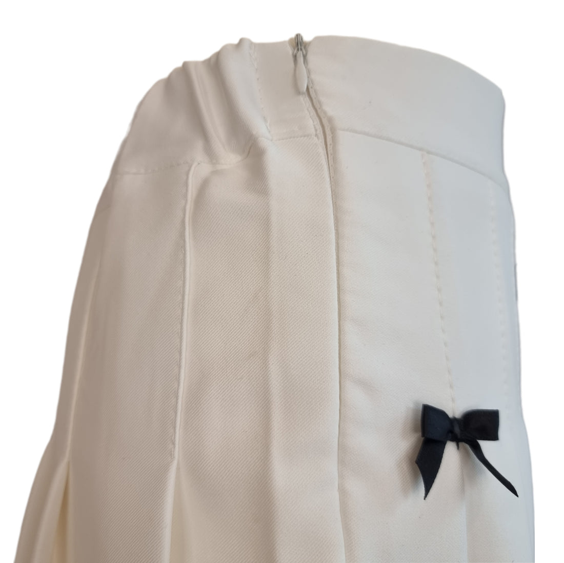 White Pleated Mini Skirt with Black Bow Embellishments