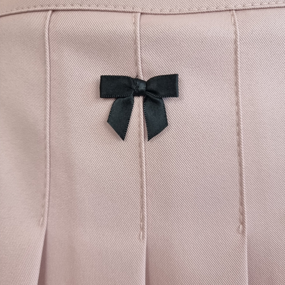 Blush Pink Pleated Mini Skirt with Black Ribbon Bow Accents