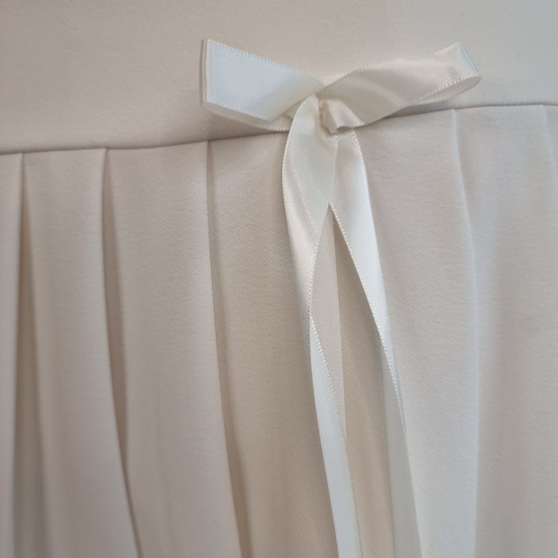 Ivory Pleated Mini Skirt with Satin Ribbon Bows